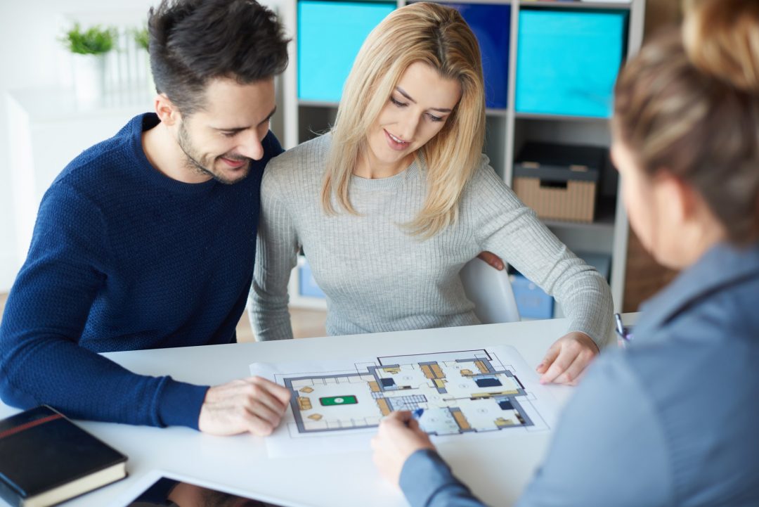 A couple meeting with a real estate agent